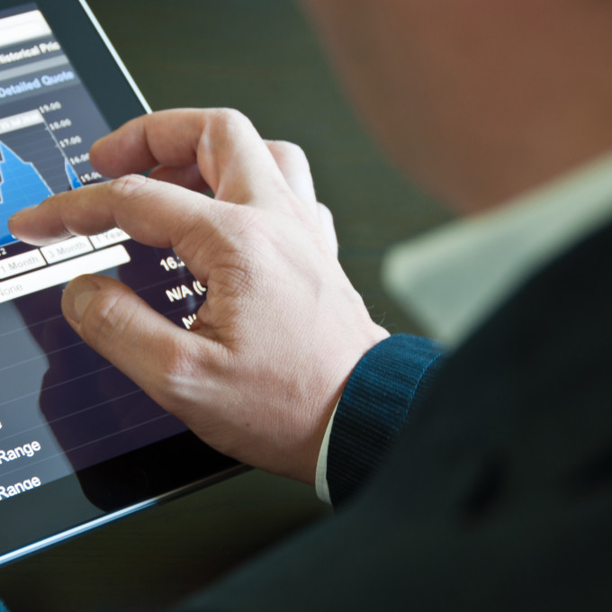 Closeup of a businessman accessing his digital tablet PC